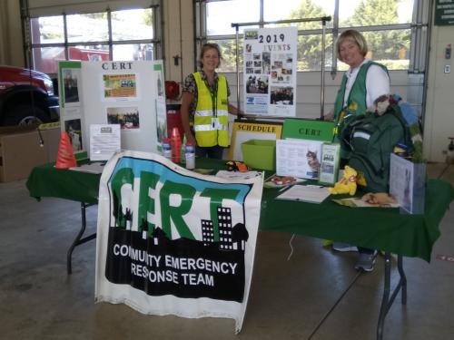 2 Women standing at CERT booth.