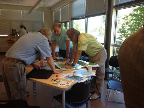 Three Employees Reviewing a Map