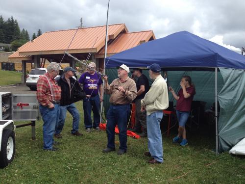 People Gathered by a Tent